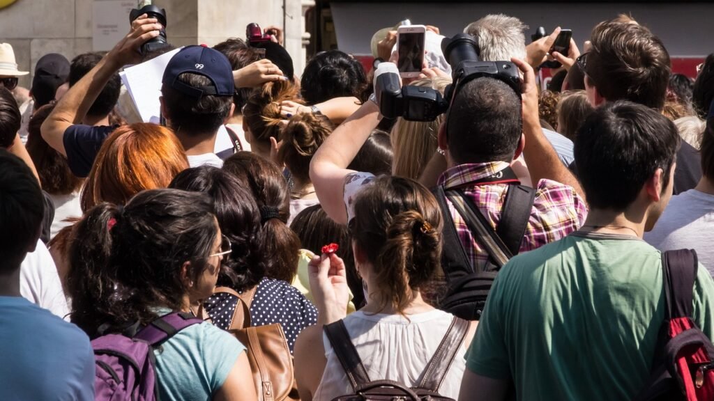 Personas con cámaras en un lugar turístico, mostrando el efecto del turismo masivo en destinos populares.